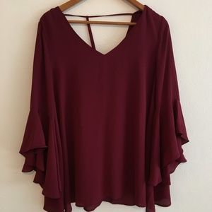 Burgundy blouse “T” Strap back.  Bell sleeves.